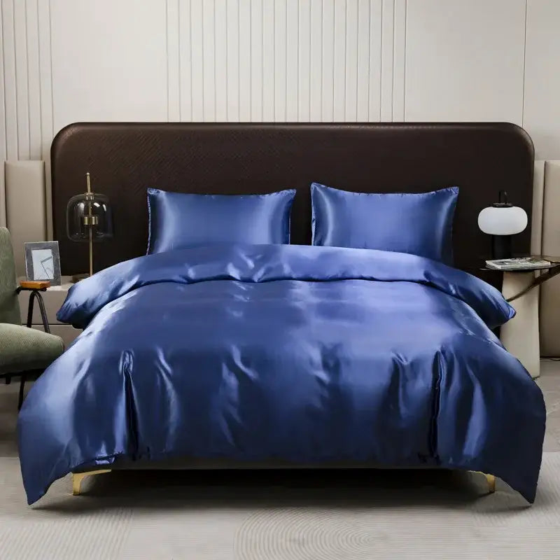 Royal blue satin duvet cover and pillowcase set elegantly draped over bed for decorbites ice rayon bedroom bedding