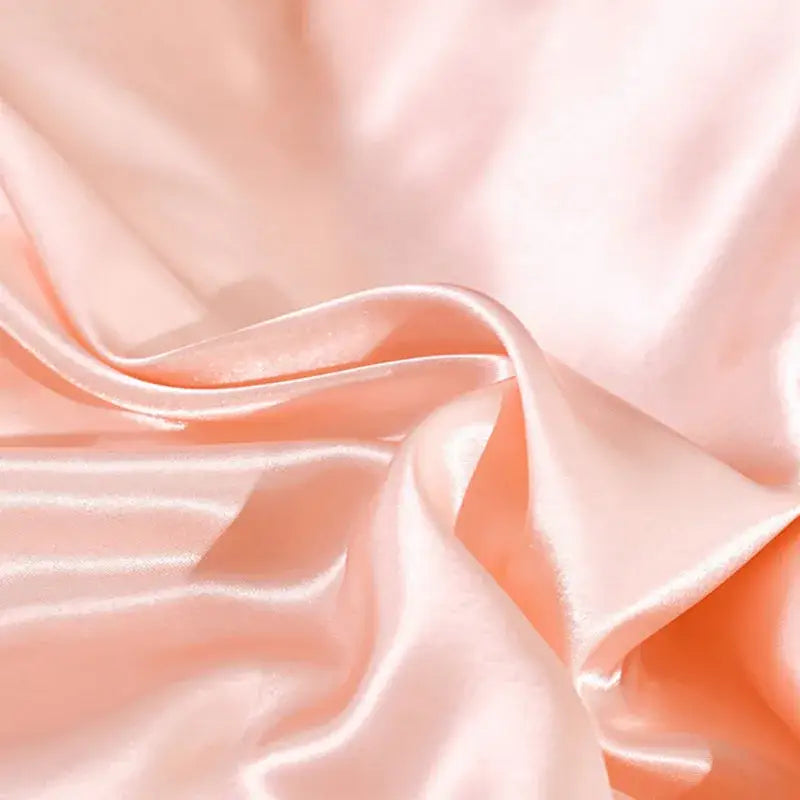 Luxurious peach satin duvet cover and pillowcase set with a smooth glossy finish made from decorbites ice rayon fabric