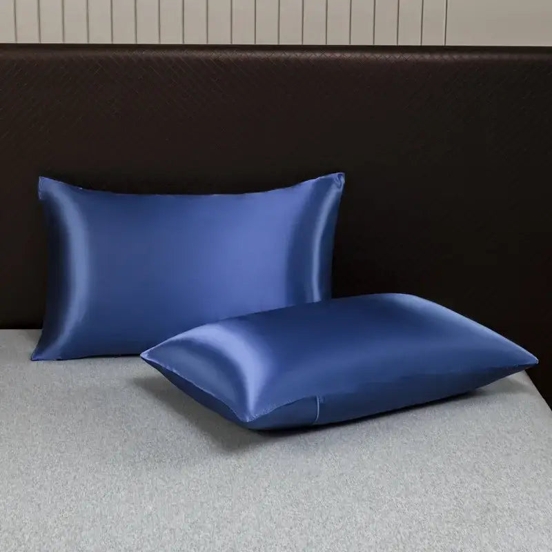 Two elegant royal blue satin pillowcases with a smooth glossy finish in a decorbites ice rayon pillowcase set