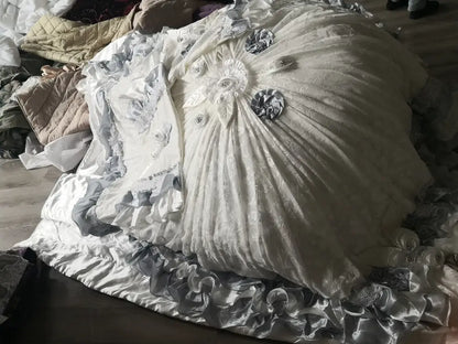 A voluminous white satin gown with silver lace and floral appliqués featured alongside decorbites jacquard rose lace bedding set