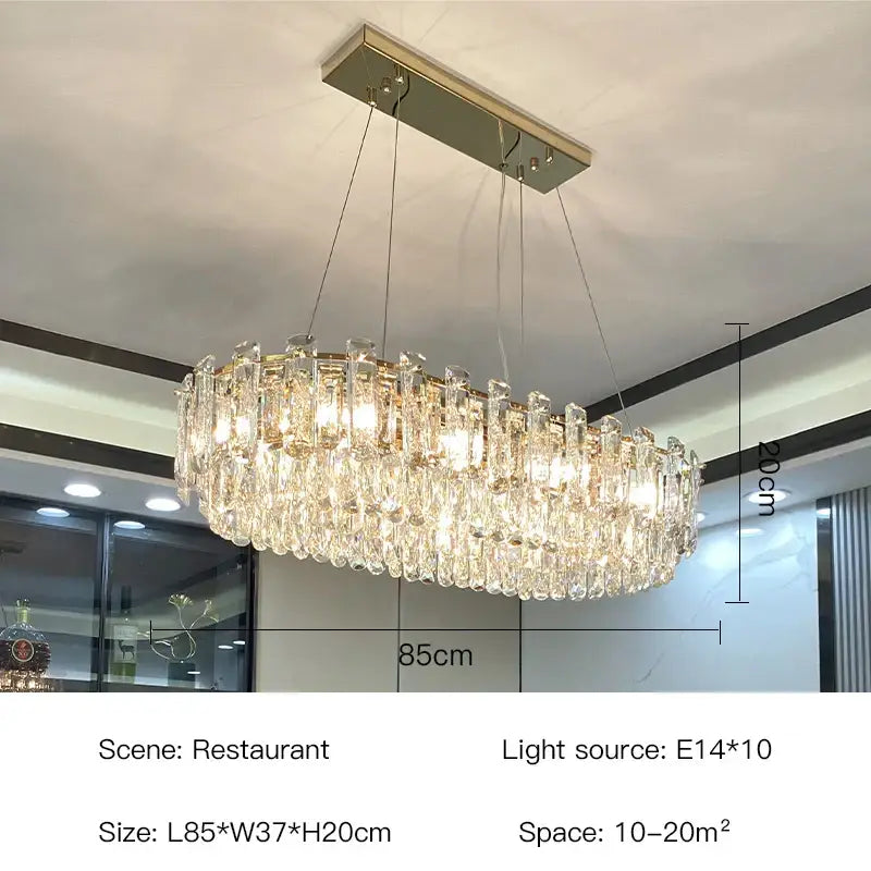 A luxurious two tier gold round oval crystal chandelier with cascading clear prisms and metallic ceiling mount for dining room decorbites gold round