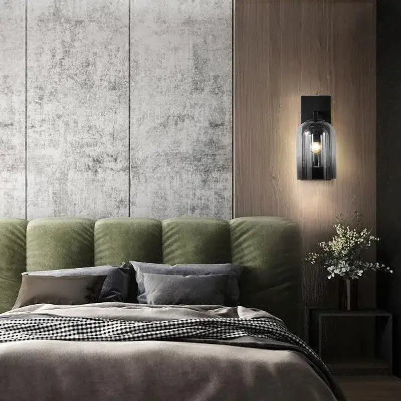 Black-framed luxury amber glass wall art light with smoked glass bell-shaped shade and exposed bulb for bedroom use