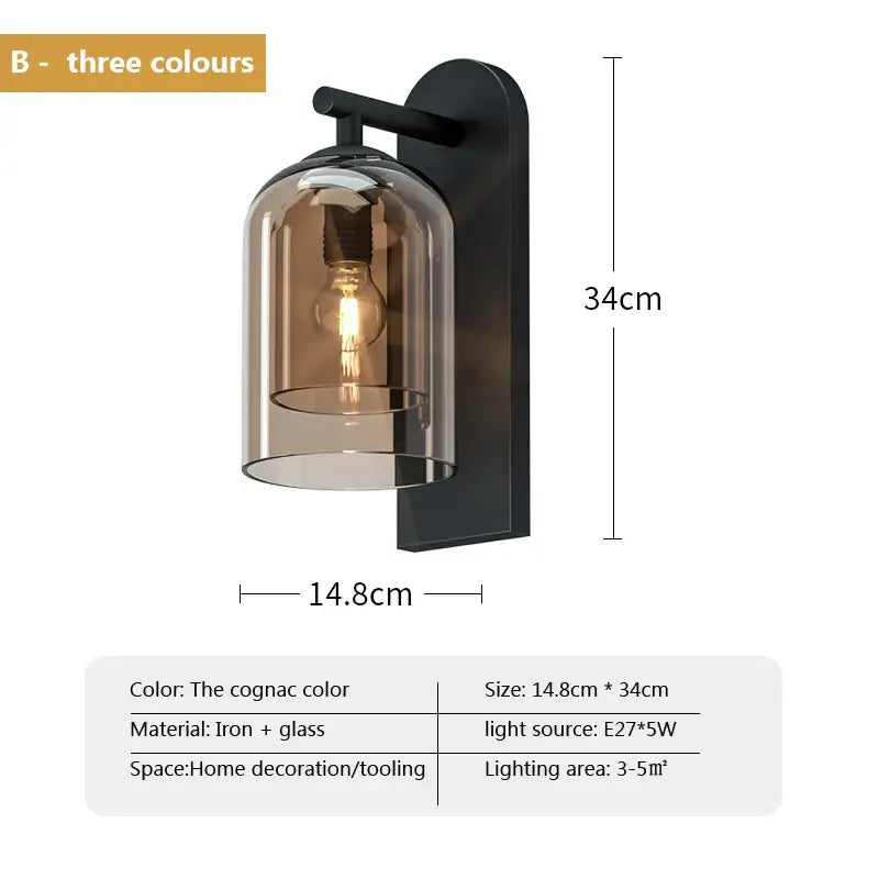 A sleek black iron and cognac-tinted glass wall art light sconce with an exposed bulb for bedroom decor