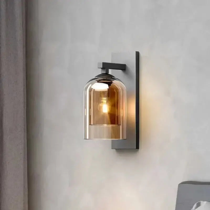 Luxury amber glass wall art light featuring a warm-toned amber glass lantern with a sleek black metal bracket sconce