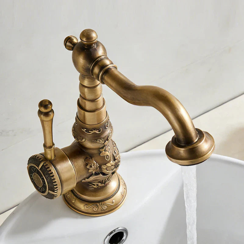 Antique bronze copper deck mounted bathroom faucet with single hole lever handle and ornate floral scrollwork for cold water control