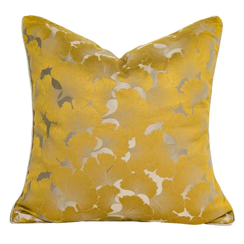 A square plush gold quatrefoil geometric pillow cover with intricate metallic silver and cream floral decorbites design