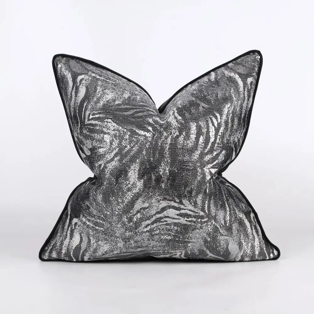A luxury black and gold geometric decorbites jacquard cushion cover with a silver and black butterfly-shaped pillow design