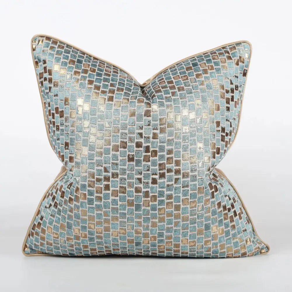 A luxury black and gold geometric decorbites jacquard cushion cover featuring a light blue and metallic gold mosaic pattern with beige border