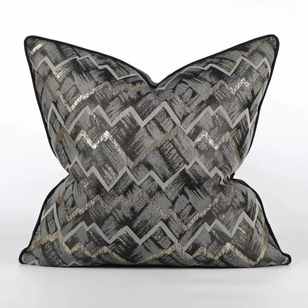 A luxury black and gold geometric jacquard cushion cover with bold zigzag pattern in gray black and metallic gold thread by decorbites jacquard high-end