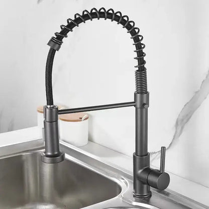 Luxury black and gold kitchen faucet with pull out spring hose featuring a black matte finish and flexible gooseneck spout
