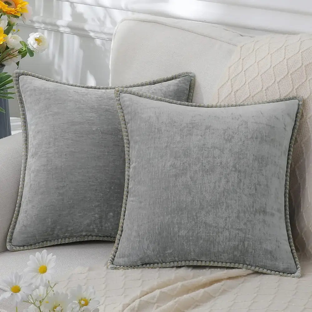 Gray velvet throw pillows with subtle texture and pom-pom trim complement luxury blue chenille cushion covers decorbites