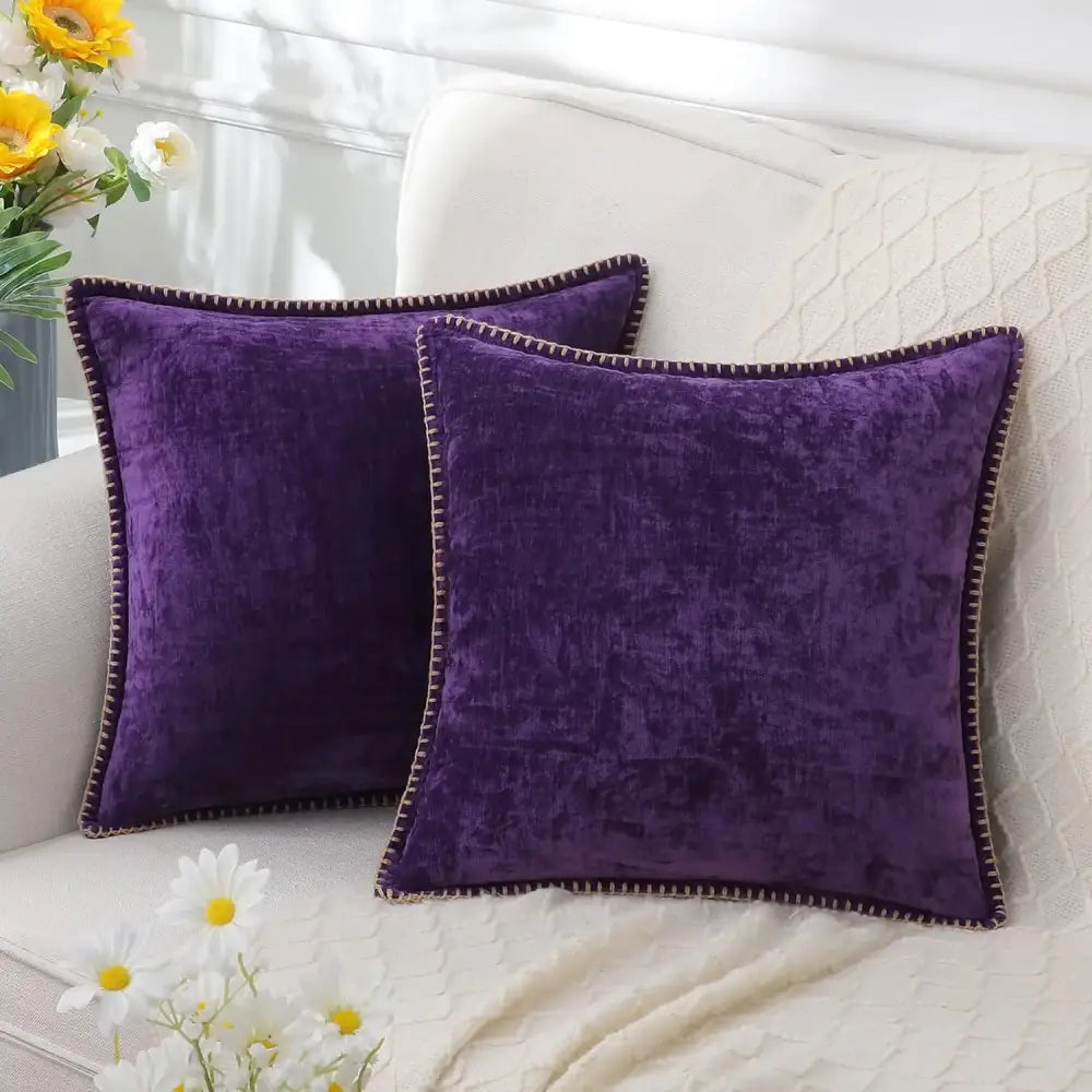Two plush deep purple velvet throw pillows with dark brown stitched edges for luxury blue chenille cushion covers decorbites