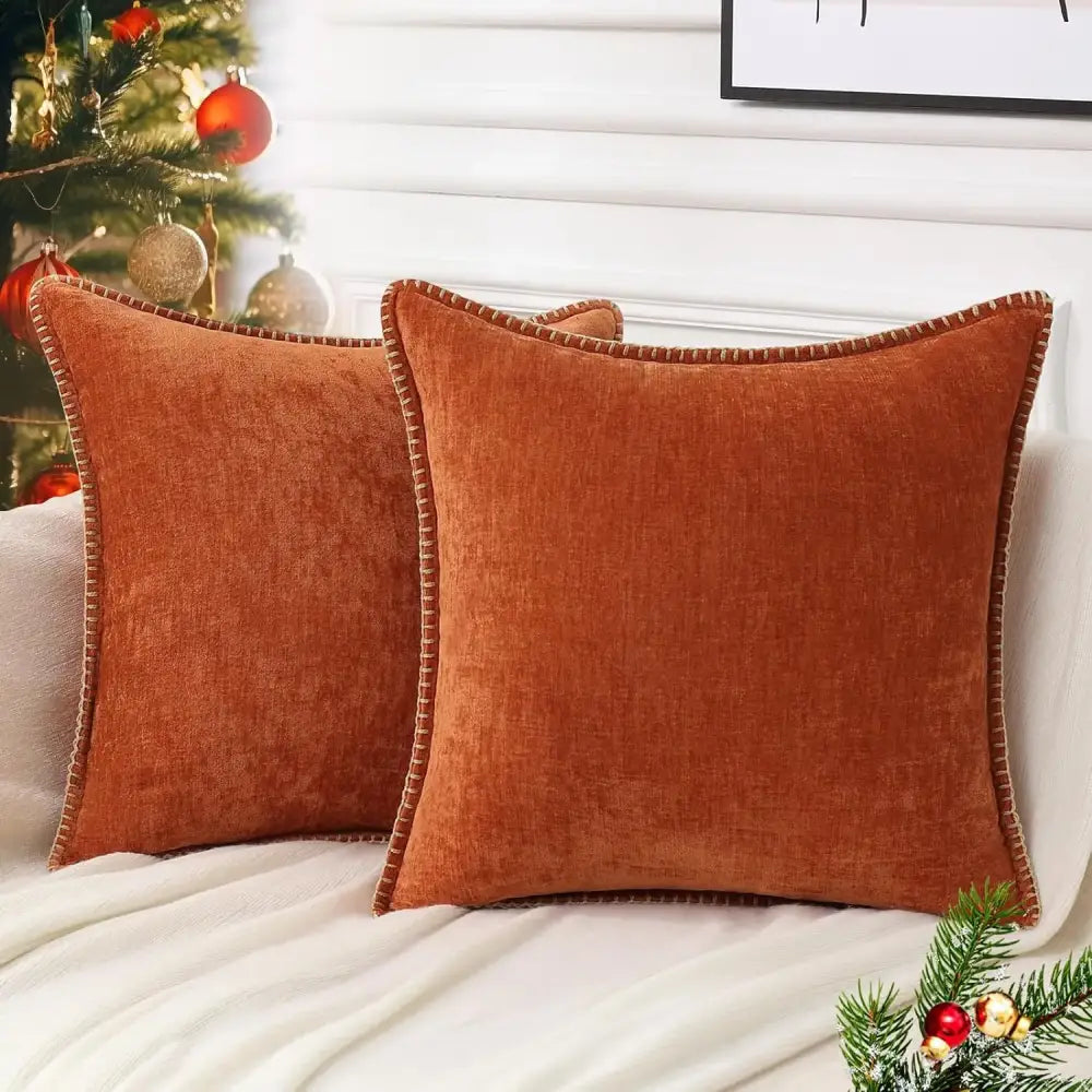 Warm rust-colored velvet throw pillows with textured weave and dark brown trim complement decorbites blue chenille cushion covers