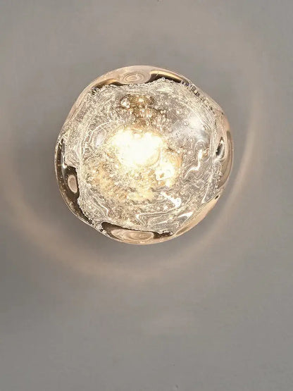 Luxury blue crystal glass wall lamp with translucent bubble-filled sconce and warm glow for elegant bedroom decorbites blue crystal