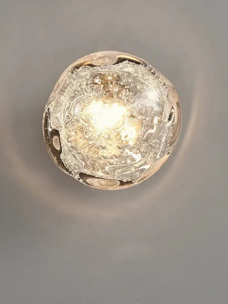 Luxury blue crystal glass wall lamp with translucent bubble-filled sconce and warm glow for elegant bedroom decorbites blue crystal