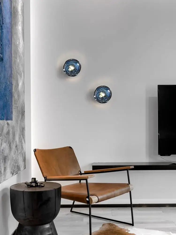 Two circular luxury blue crystal glass wall lamps with textured reflective surface decorbites blue crystal bedroom sconce