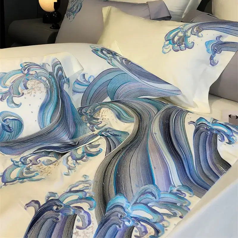 Elegant cream-colored satin bedding set featuring blue tides waves embroidery with dynamic hand-painted wave pattern