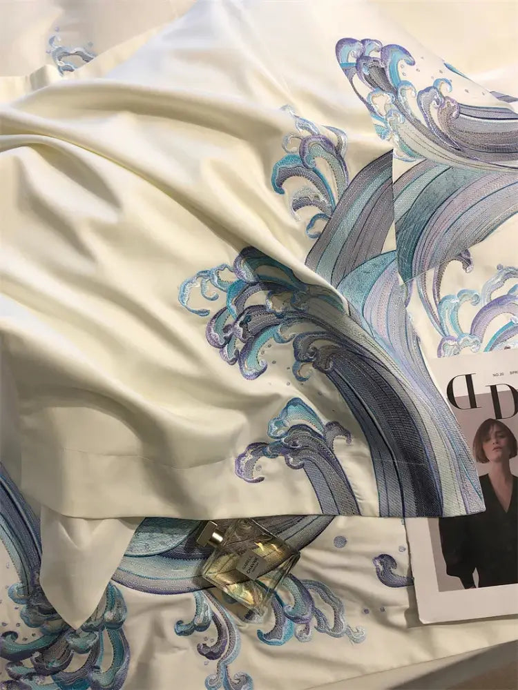Cream-colored satin bedding set with luxury blue tides waves embroidery in blue and purple for bedroom use