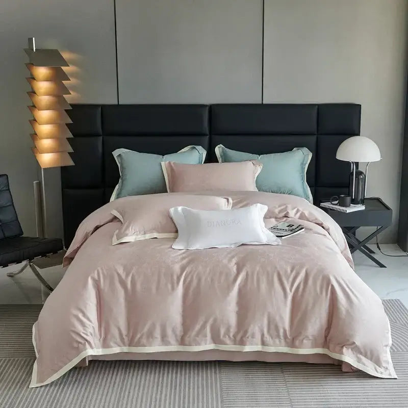 Luxury blush pink floral jacquard duvet cover set with soft satin texture and cream trim elegantly draped on bed