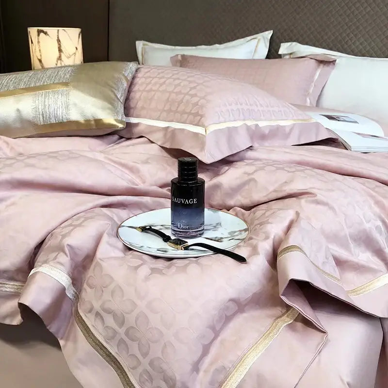 A sleek black dior sauvage perfume bottle with glossy finish on a white plate alongside luxury blush pink floral jacquard duvet cover set