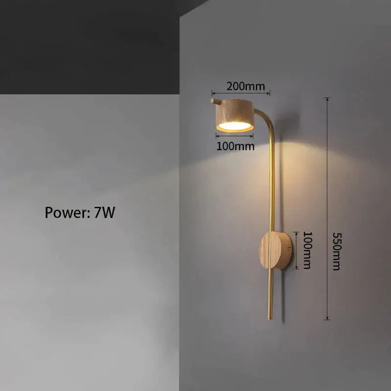 Luxury brass wall lamp with black walnut wood cylindrical shade emitting warm golden light for bedroom reading