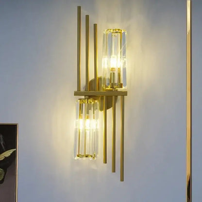 Luxury brass crystal wall lamp with gold-toned vertical rods and ribbed clear glass cylinders for bedroom decorbites crystal wall