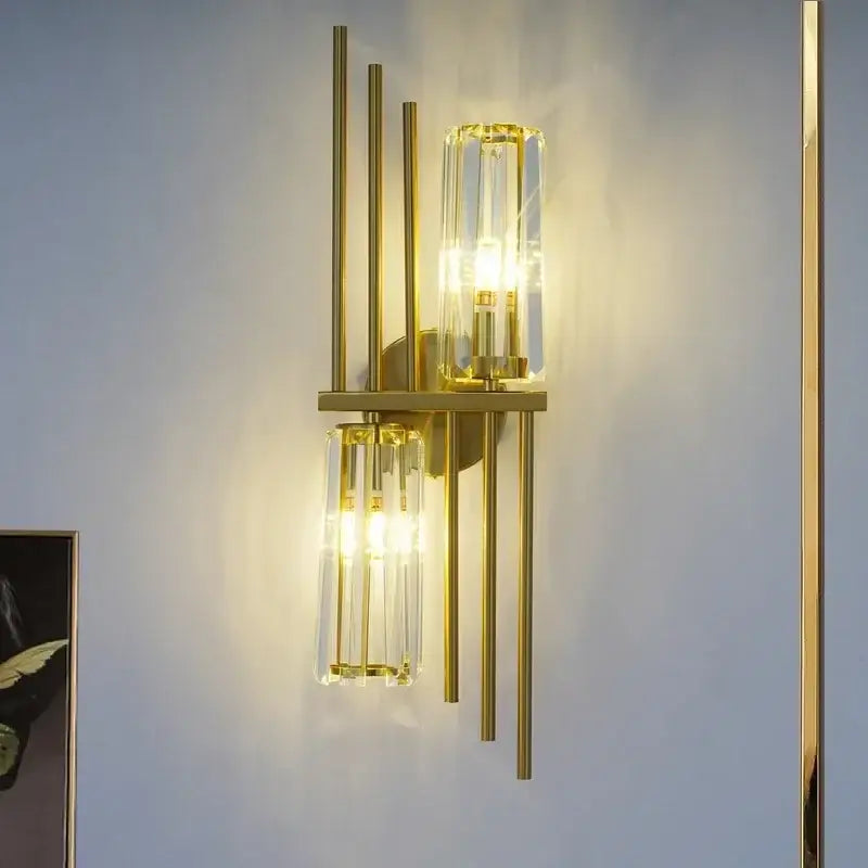 Luxury brass crystal wall lamp with gold-toned vertical rods and ribbed clear glass cylinders for bedroom decorbites crystal wall