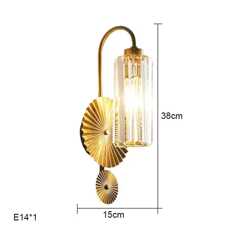 Luxury brass crystal wall lamp with gold-toned curved arm, ribbed crystal glass shade, and fan-shaped metal decorbites crystal wall accent
