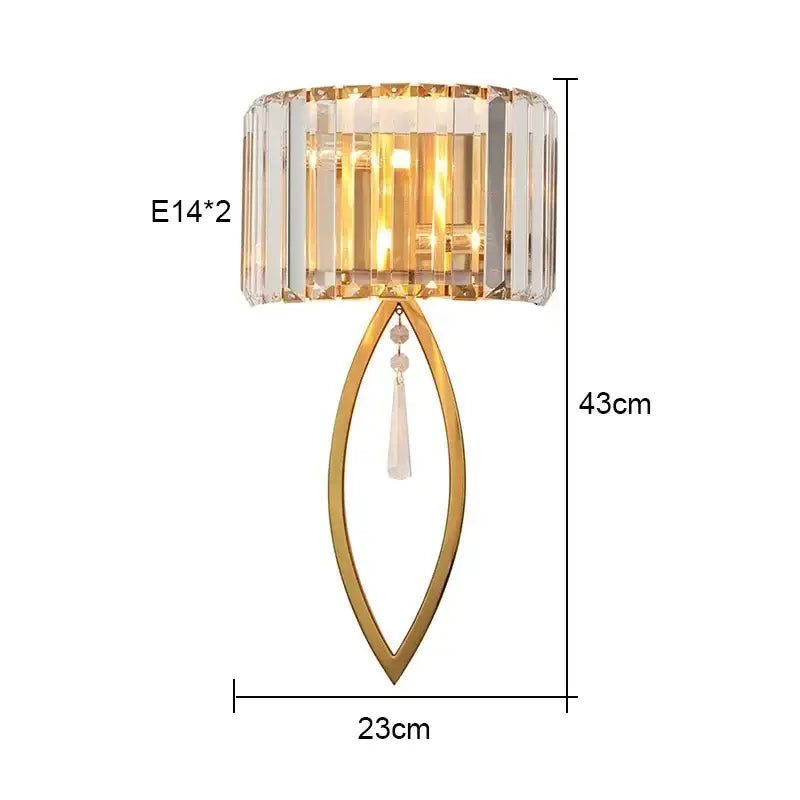 Gold-toned luxury brass crystal wall lamp with faceted shade and teardrop pendant for elegant bedroom decorbites crystal wall lighting
