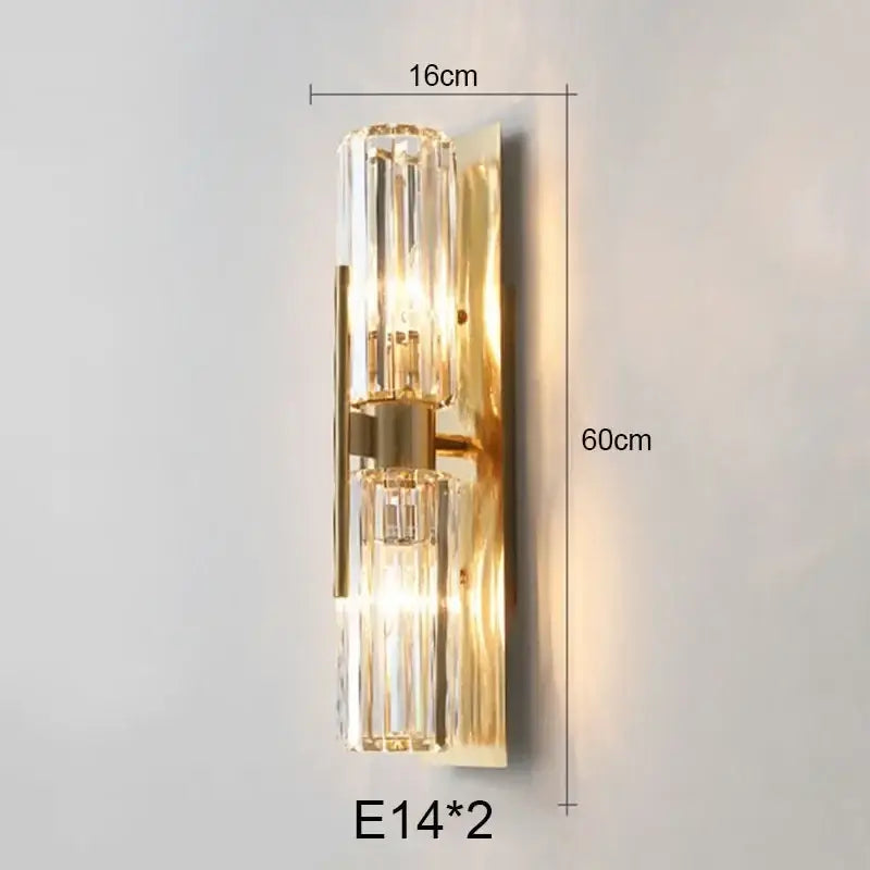 Luxury brass crystal wall lamp with gold-toned metallic backplate and two vertical ribbed crystal glass shades decorbites crystal wall