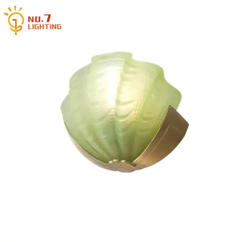 Luxury brass glass shell wall lamp featuring a translucent green glass cabbage design with a brass base by no7 lighting