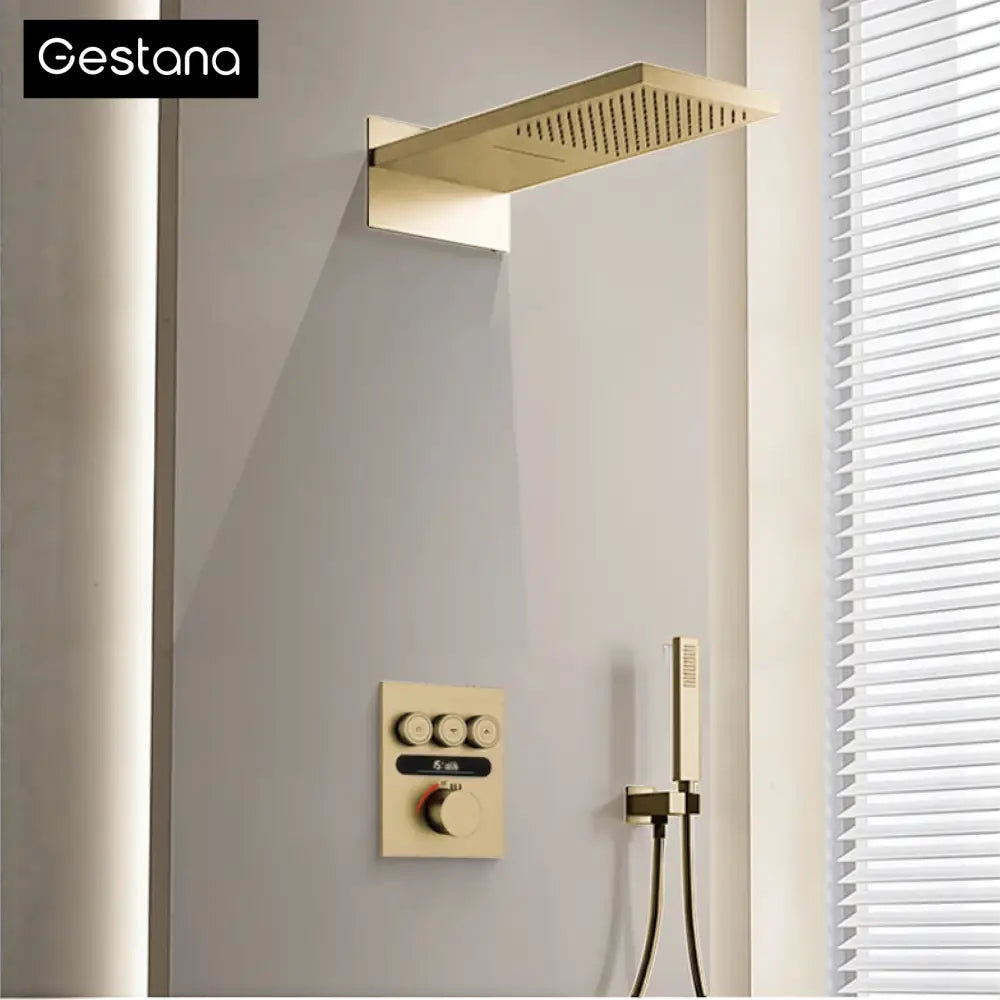 Luxury brushed gold digital rainfall shower system with gold-finished rectangular showerhead and matching control panel and handheld shower