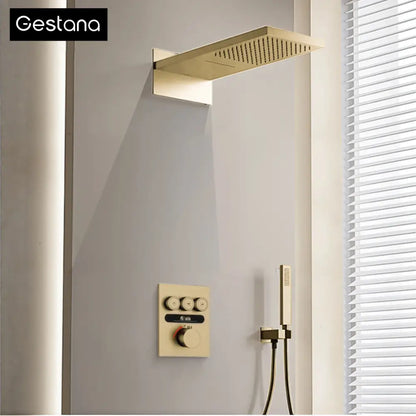 Luxury brushed gold digital rainfall shower system with gold-finished rectangular showerhead and matching control panel and handheld shower