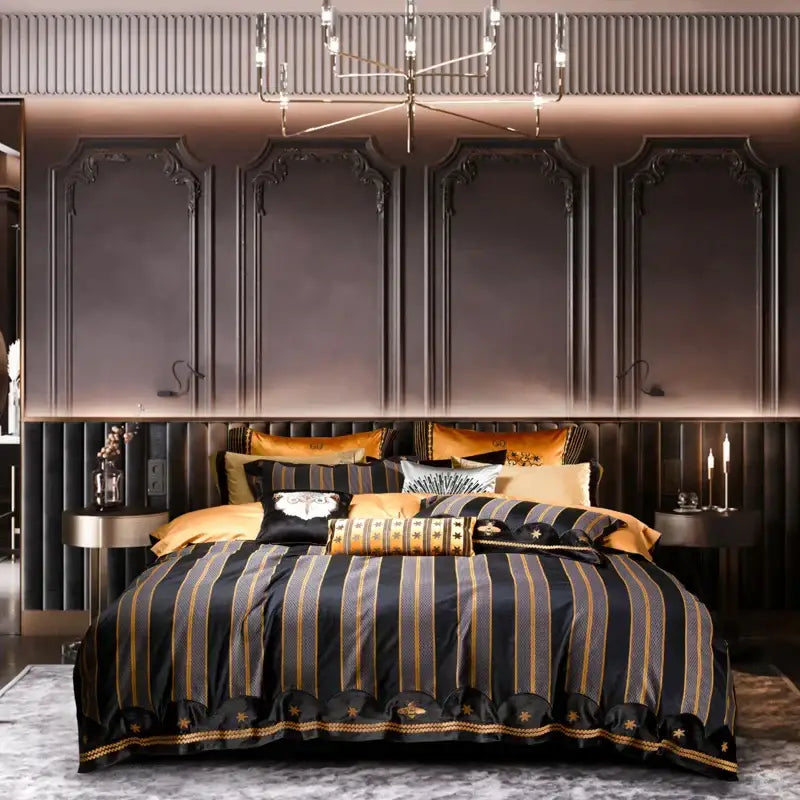 Luxury burgundy red egyptian cotton bedding set featuring a black and gold striped duvet cover with embroidered stars and scalloped hem
