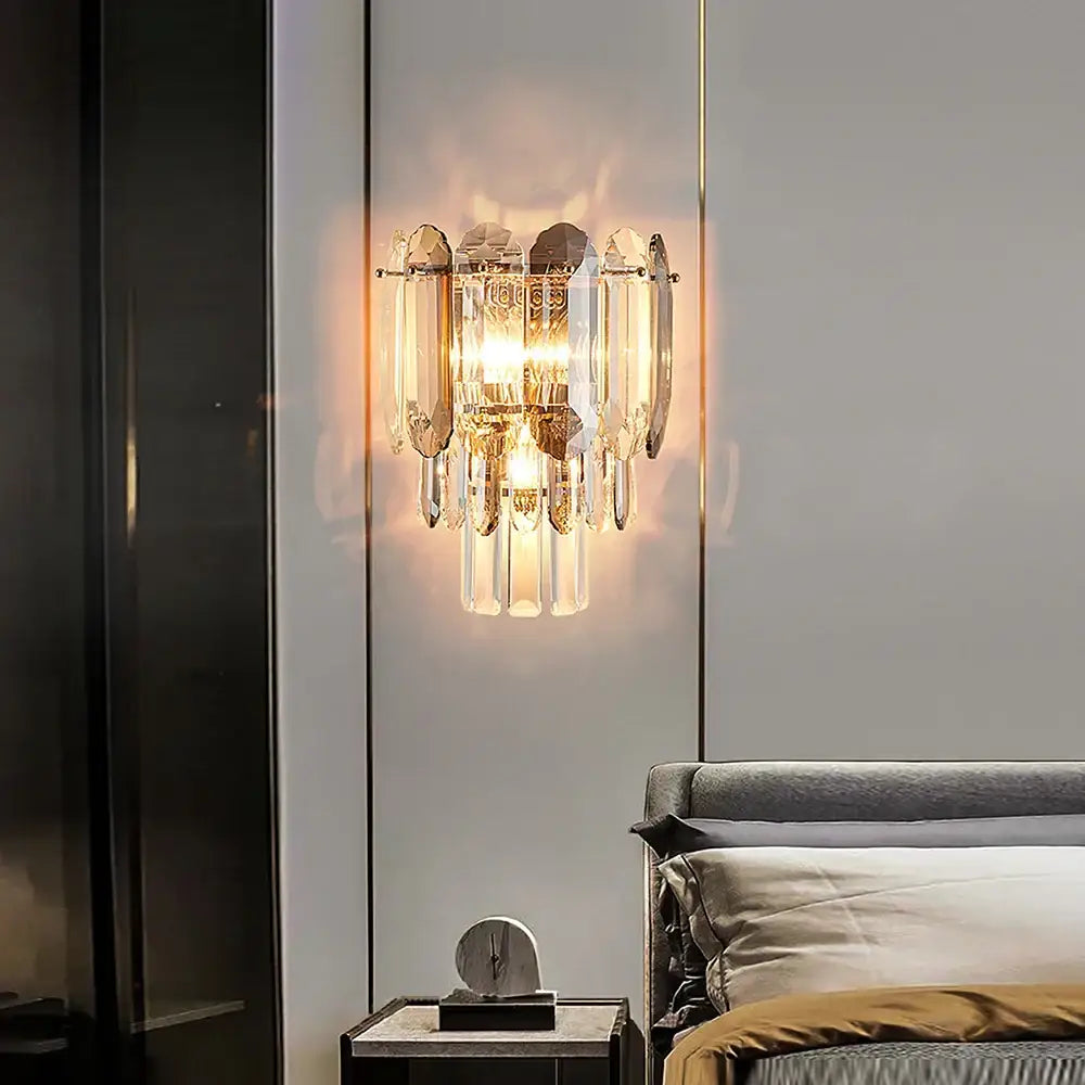 Gold-toned wall lamp with cascading crystal prisms and warm glowing light for luxury decorbites crystal led wall lighting