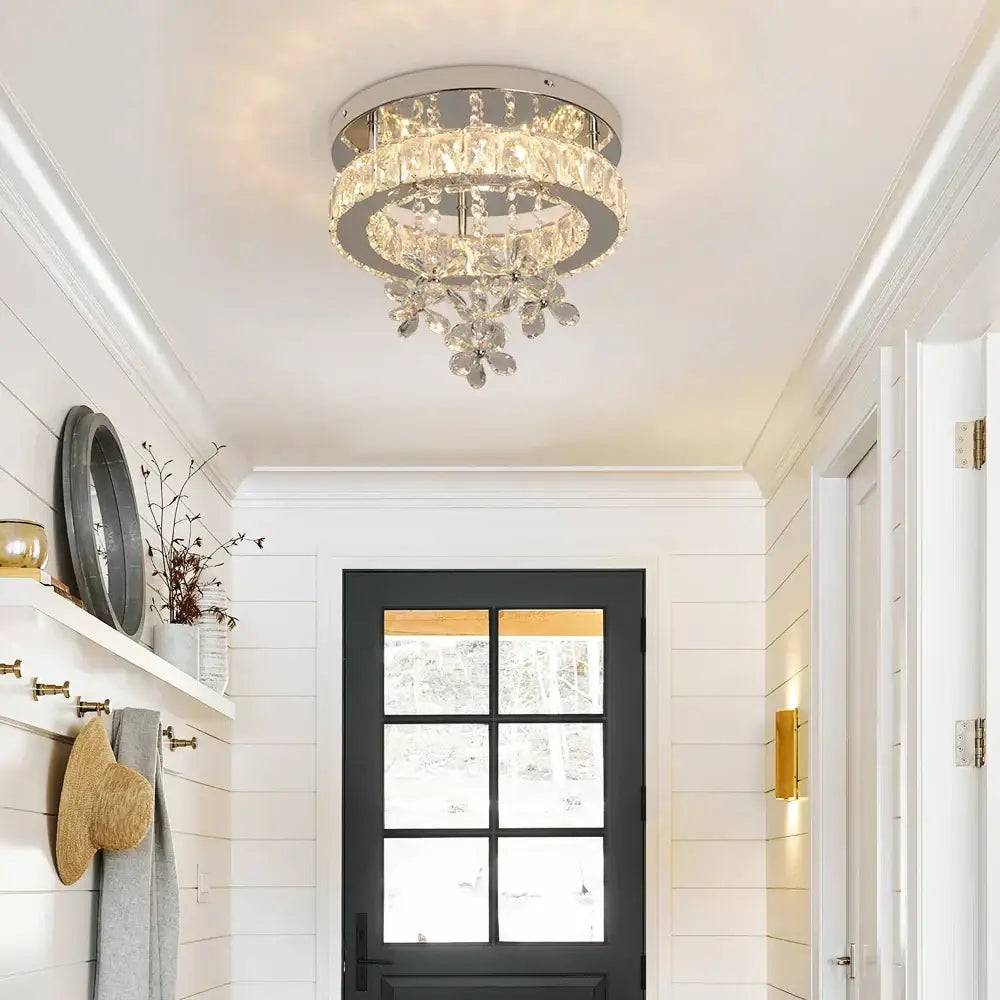Luxury chrome crystal led ceiling chandelier with faceted glass tiers emitting warm light for living room decorbites crystal led