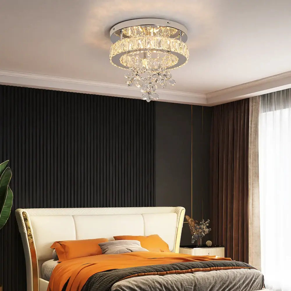 Luxury chrome crystal led ceiling chandelier with faceted glass tiers emitting warm light for living room decorbites crystal led