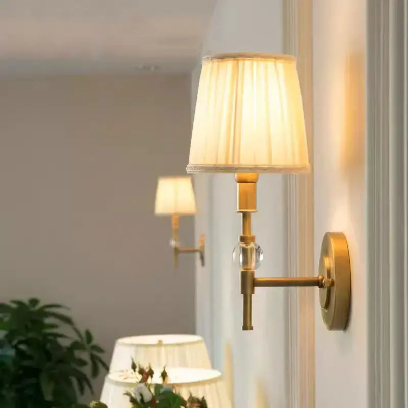 Luxury copper wall lamp featuring a brass wall sconce with cream pleated fabric shade and clear crystal accent decorbites copper wall
