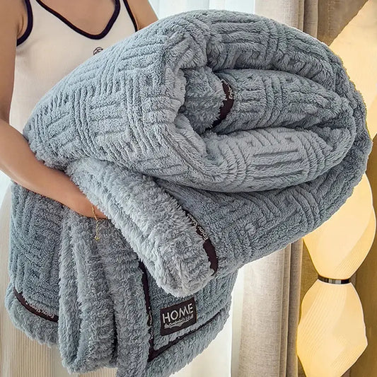Luxury coral fleece winter blanket in light gray with textured woven pattern and dark brown trim for bedroom use