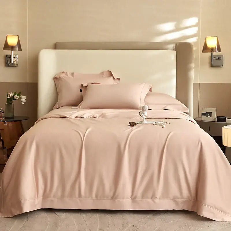 A soft blush pink satin bedding set with matching duvet and pillows on a modern headboard decorbites 1400tc pima cotton