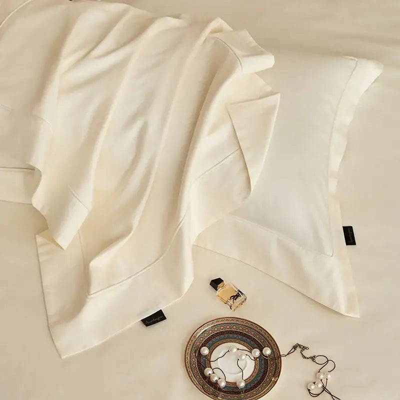 Cream-colored silk pillowcase with subtle sheen and stitched edges from decorbites 1400tc pima cotton bedding set