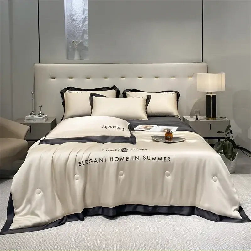 Luxury cream and black ice silk embroidered quilt set featuring a cream satin duvet cover with black trim and elegant text