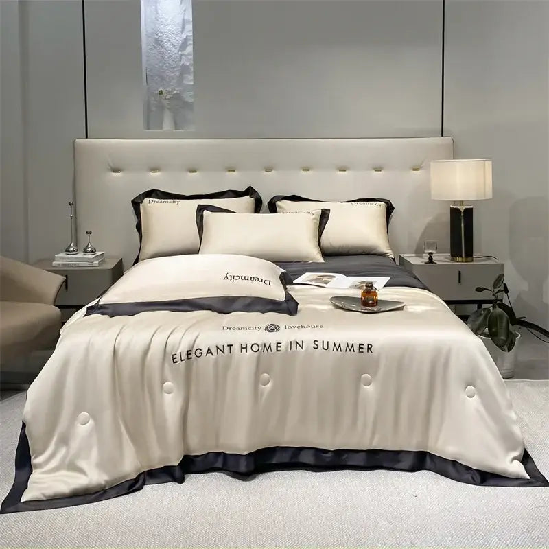 Luxury cream and black ice silk embroidered quilt set featuring a cream satin duvet cover with black trim and elegant home text