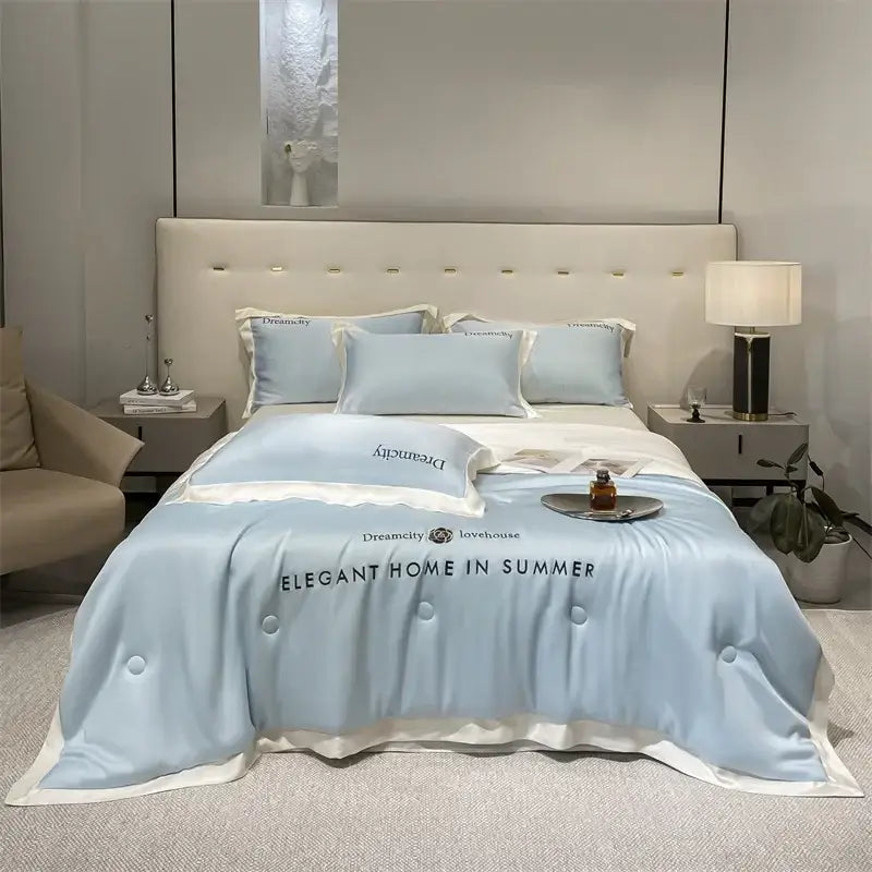 Luxury cream and black ice silk embroidered quilt set with light blue satin duvet cover and white trim featuring decorbites ice silk design