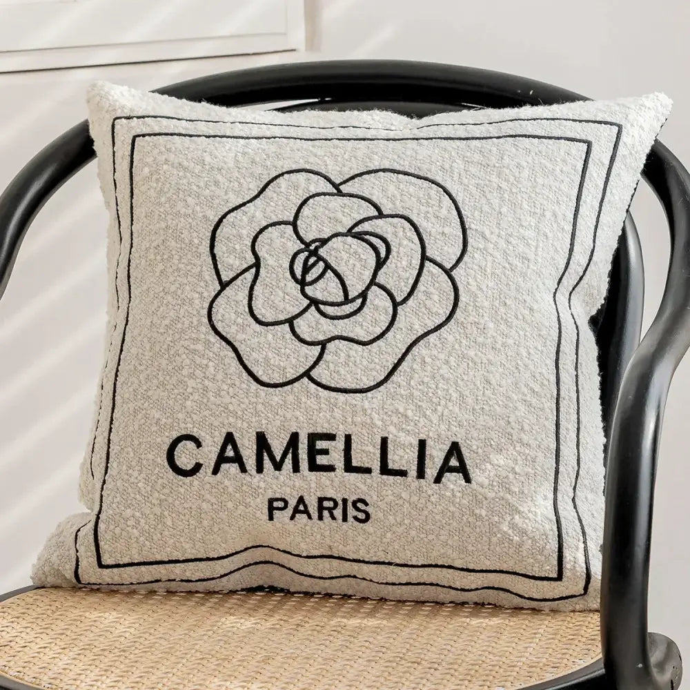 Luxury cream and black decorbites camellia jacquard pillow cover with textured beige fabric and black embroidered flower design