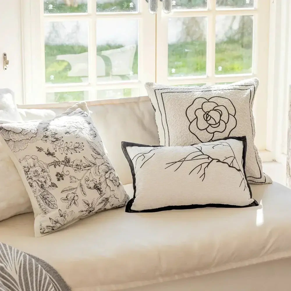 Luxury cream and black decorbites camellia jacquard pillow cover with embroidered floral design and contrasting piping