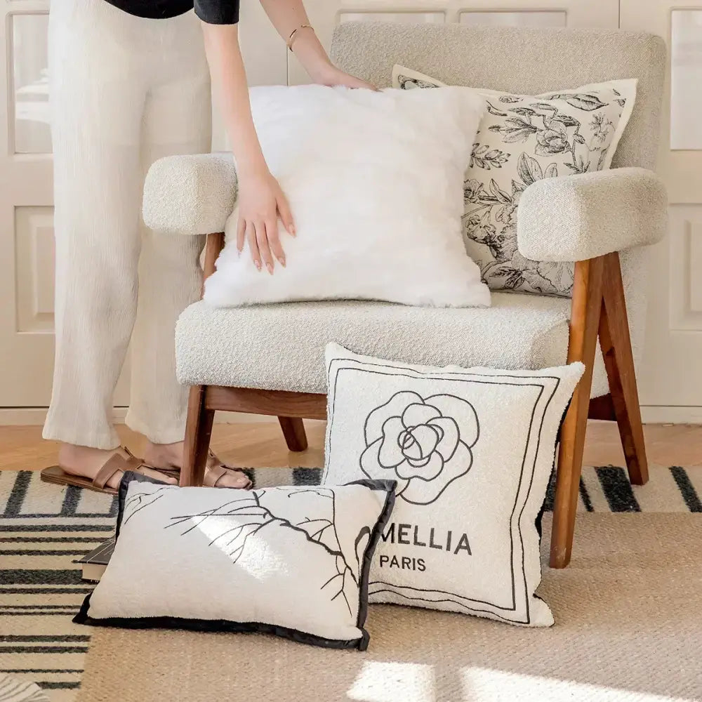 White textured throw pillow cover with black floral decorbites camellia jacquard and mellia paris branding for living room decor
