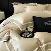 Cream-colored satin bedding set with gold-toned 1000tc luxury embroidery and black princess rhinestone pillow by decorbites