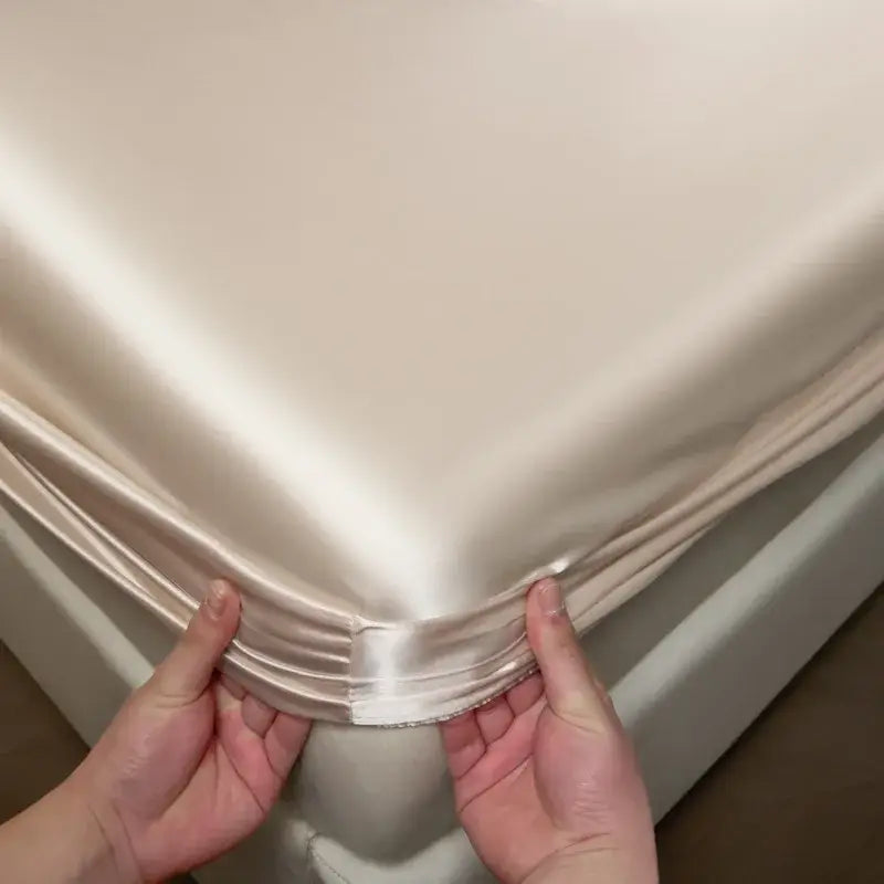 Luxury cream mulberry silk fitted sheet set featuring smooth cream satin fitted sheet with glossy finish and neatly folded edges