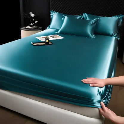Luxury cream mulberry silk fitted sheet set in teal satin with a smooth glossy finish and elegant drape for bedroom use